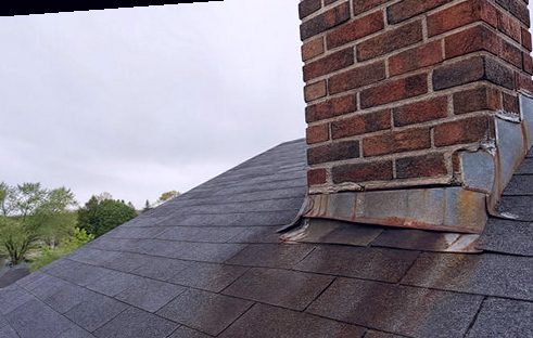 Rusted-through flashing hanging its alarm sign at a chimney base